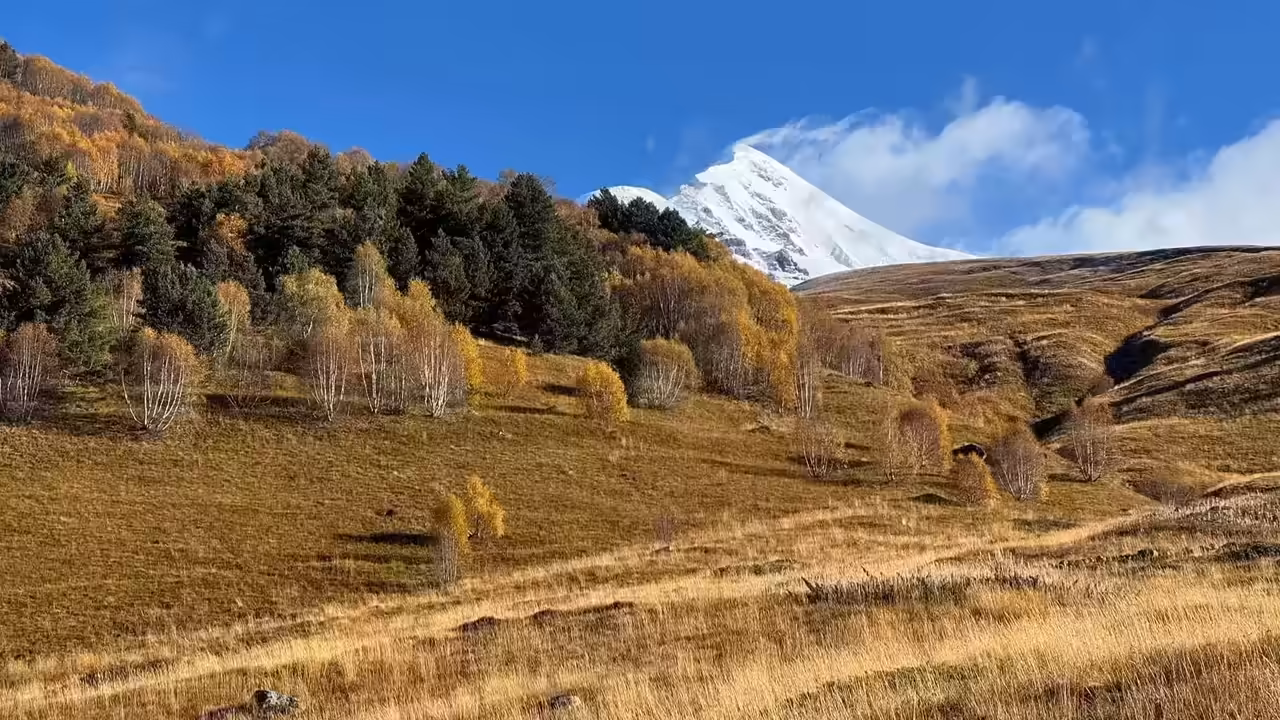 Mountain summit overlooking a pristine lake with rainbow